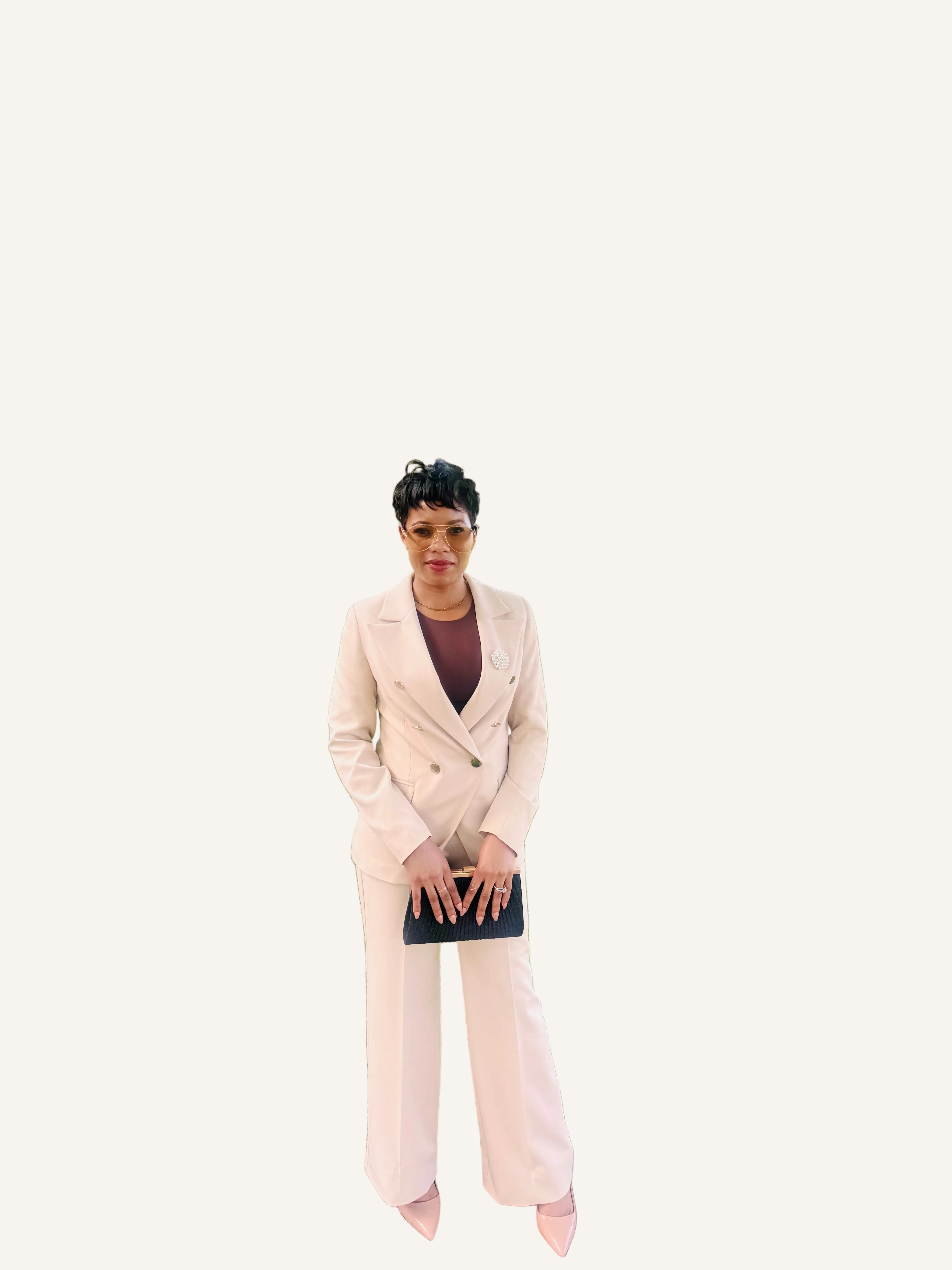 Woman wearing the Ebony Suit, an ivory double-breasted blazer and wide-leg pant set from Astine Boutik, styled for a professional daytime event
