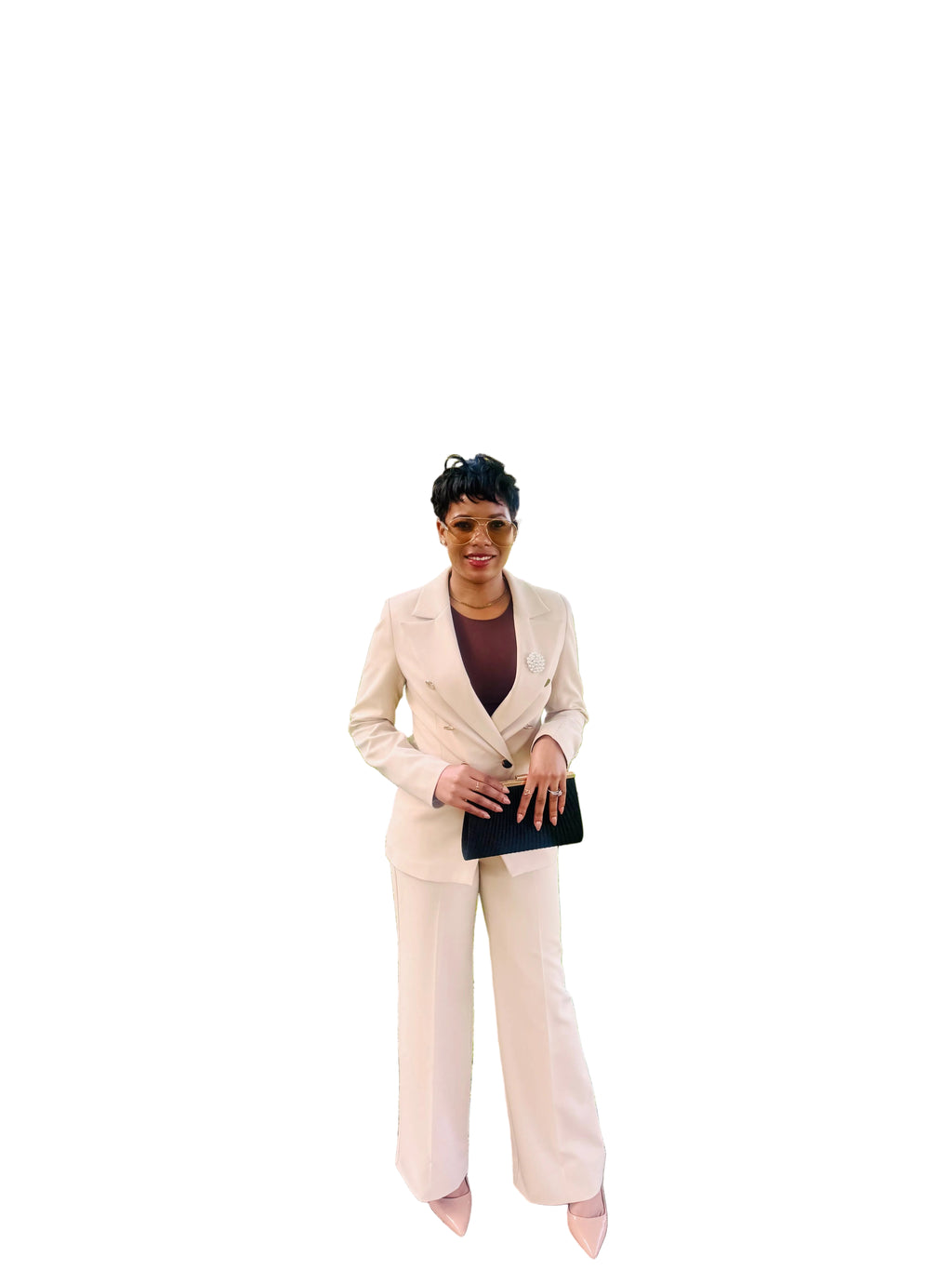 Woman wearing the Ebony Suit, an ivory double-breasted blazer and wide-leg pant set from Astine Boutik, styled for a professional daytime event