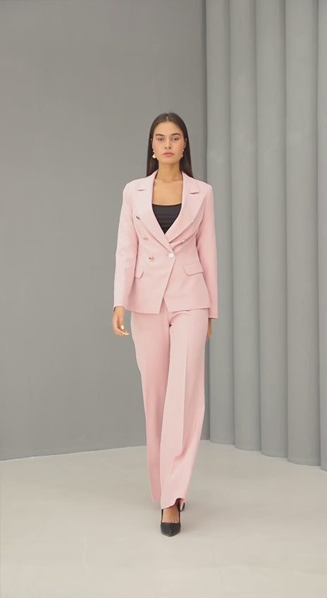 Woman wearing the Ebony Suit, an ivory double-breasted blazer and wide-leg pant set from Astine Boutik, styled for a professional daytime event